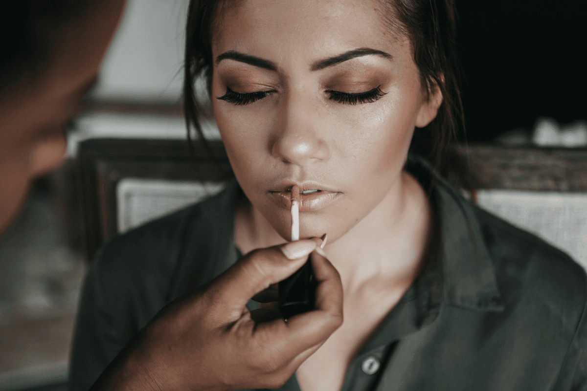 Woman applying lip gloss