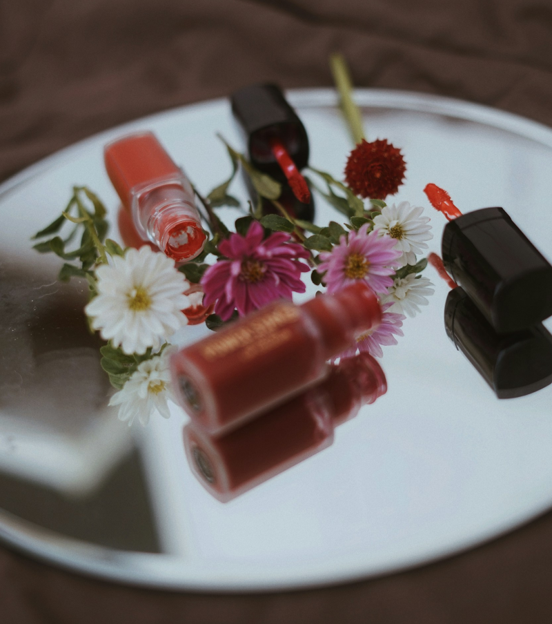 Lipsticks on a tray with flowers