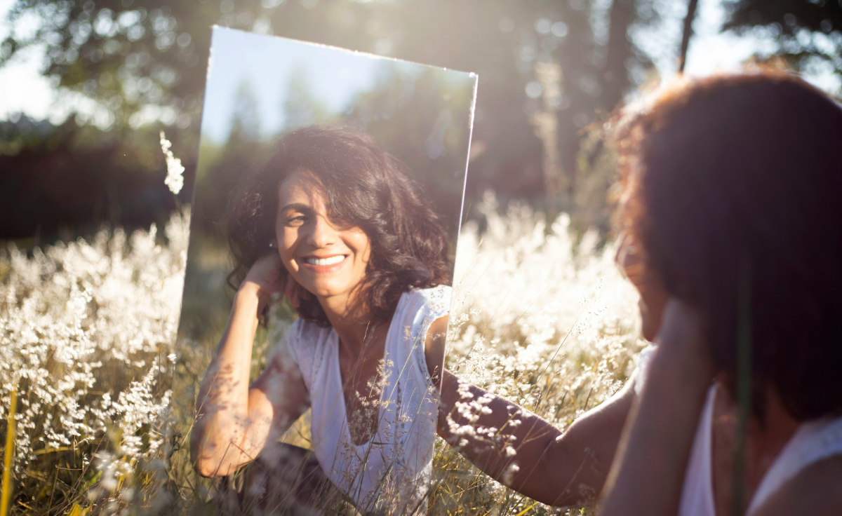 Woman holding up a mirror