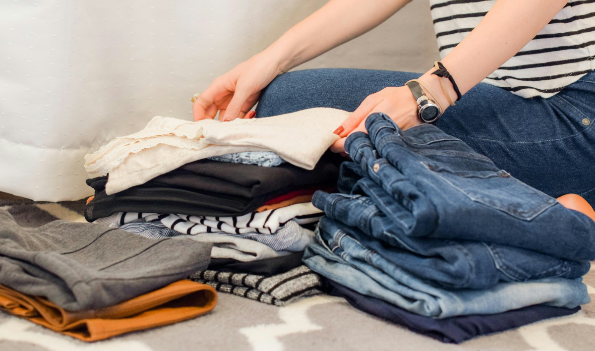 Woman putting away folded clothes